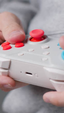 Vertical-Video-Front-On-Close-Up-Shot-Hands-Man-Playing-Video-Game-Controller-2